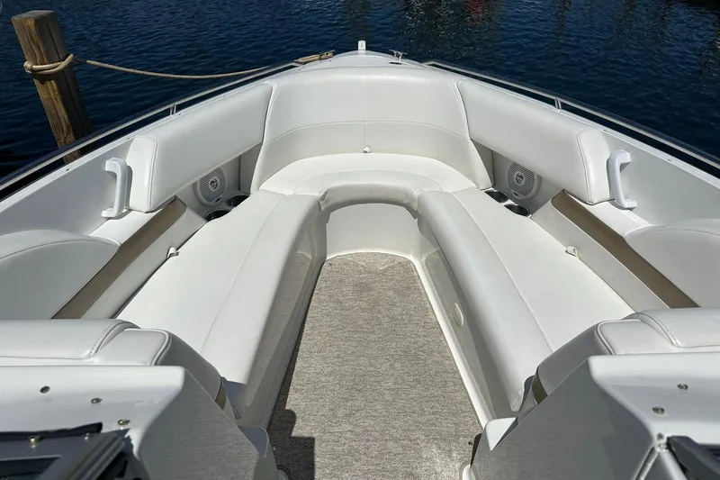 Slide: The Image of 2004 Formula 260 Bowrider boat interior with white seating and carpeted floor. - 12