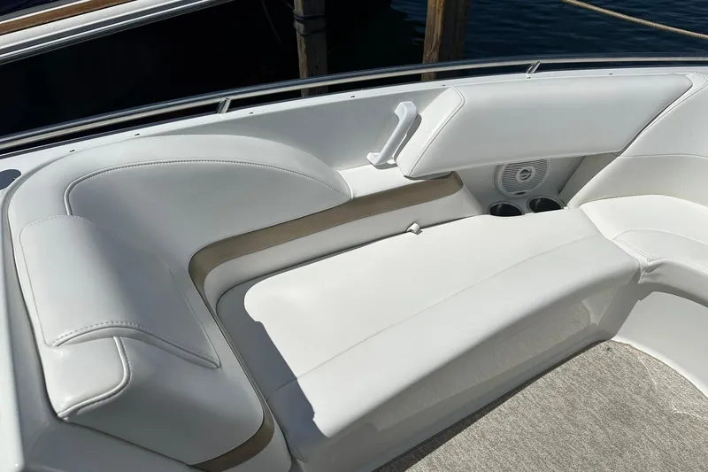 Slide: The Image of 2004 Formula 260 Bowrider boat interior with white cushioned seating and cup holders. - 13