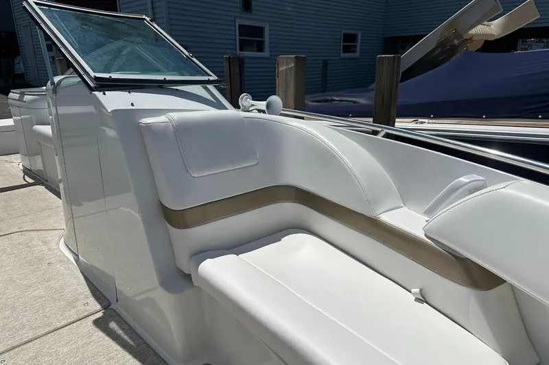Slide: The Image of 2004 Formula 260 Bowrider boat interior with white seating and windshield. - 16