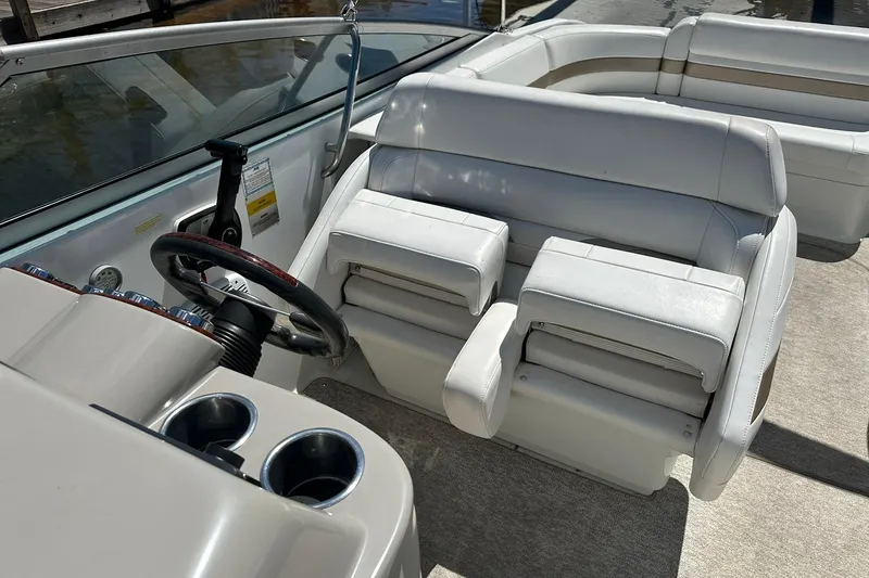 Slide: The Image of 2004 Formula 260 Bowrider interior with white seating and steering wheel. - 17