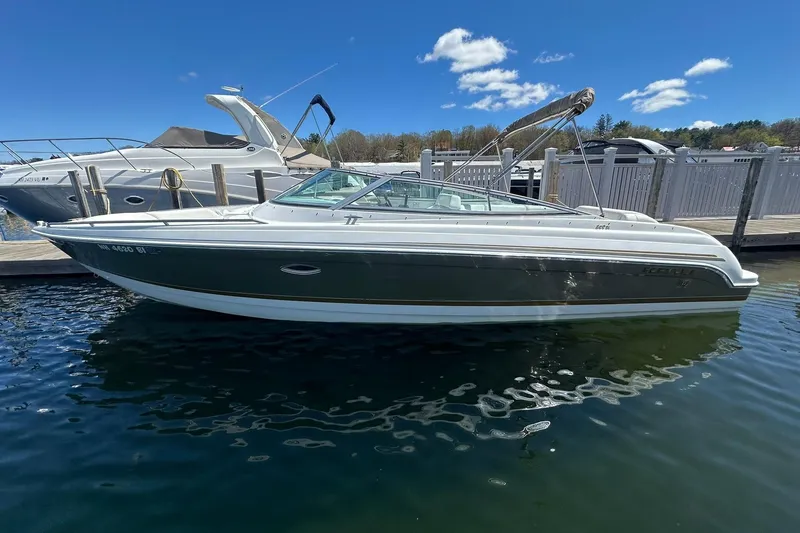 Slide: The Image of 2004 Formula 260 Bowrider boat docked on a sunny day with clear blue skies. - 2