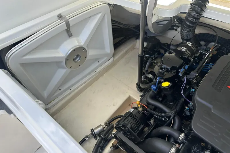 Slide: The Image of Engine compartment of a 2004 Formula 260 Bowrider boat, showcasing mechanical components. - 21