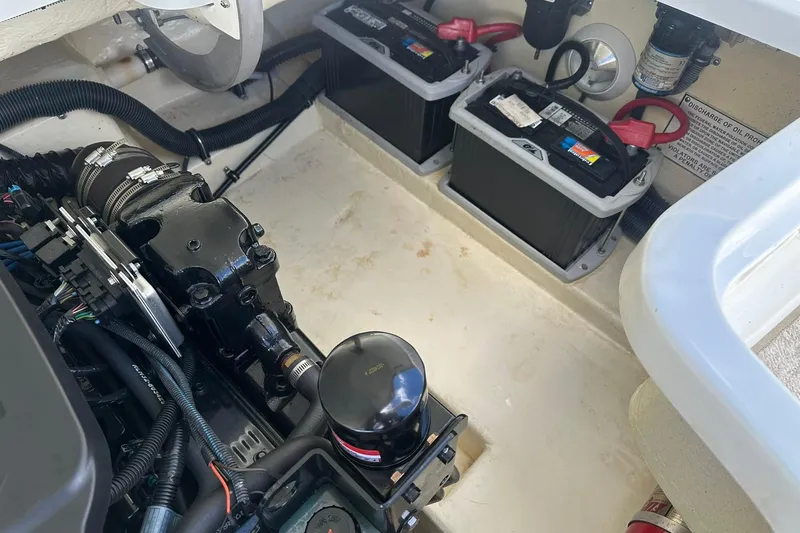 Slide: The Image of Engine compartment of a 2004 Formula 260 Bowrider with visible batteries and components. - 22