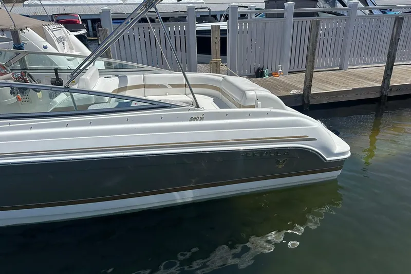 Slide: The Image of 2004 Formula 260 Bowrider boat docked at marina, featuring sleek design and spacious seating. - 4
