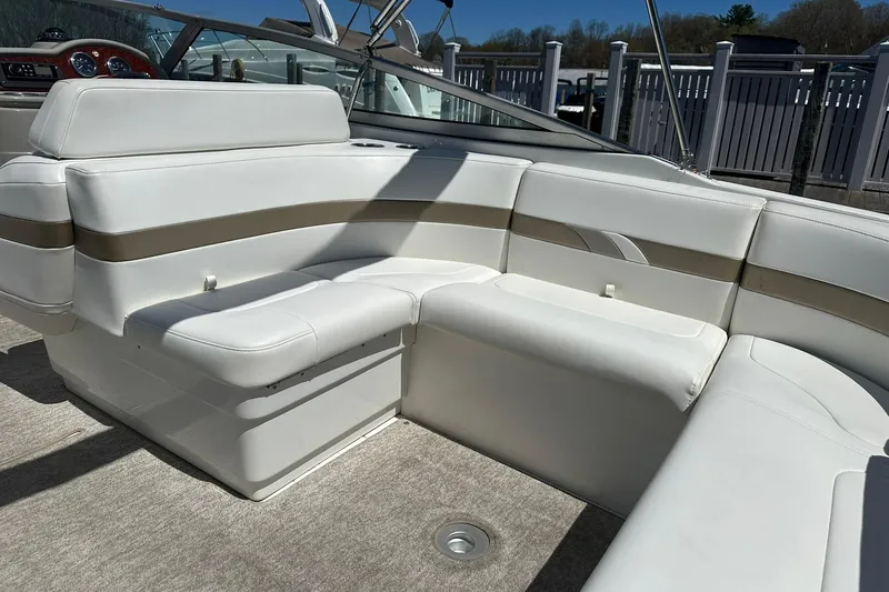 Slide: The Image of 2004 Formula 260 Bowrider boat interior with white cushioned seating and dashboard view. - 6