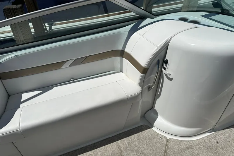 Slide: The Image of 2004 Formula 260 Bowrider interior seating with white upholstery and cup holders. - 9