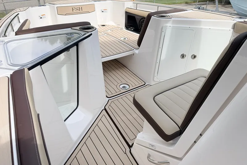 Slide: The Image of 2026 Yamaha Boats 255 FSH Sport H interior with sleek seating and modern design. - 12