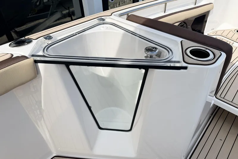 Slide: The Image of 2026 Yamaha Boats 255 FSH Sport H interior detail with cup holder and seating. - 16