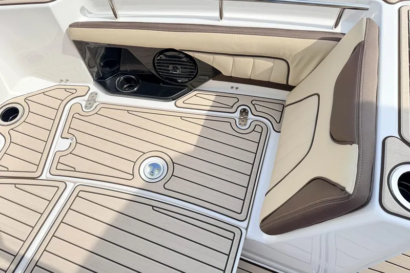 Slide: The Image of 2026 Yamaha Boats 255 FSH Sport H interior with cushioned seating and non-slip flooring. - 18