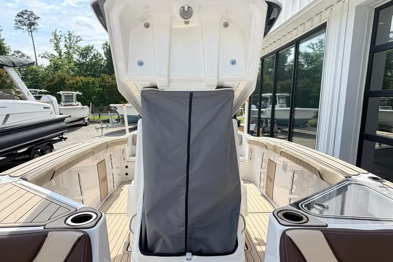Slide: The Image of 2026 Yamaha Boats 255 FSH Sport H interior with open storage compartment, showcasing sleek design. - 20