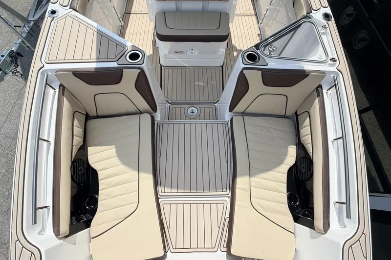 Slide: The Image of 2026 Yamaha Boats 255 FSH Sport H interior with beige seating and sleek design. - 23
