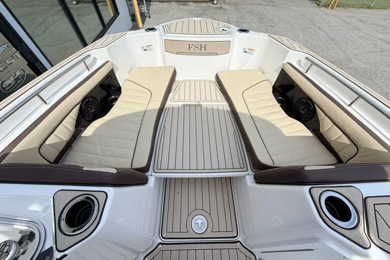 Slide: The Image of 2026 Yamaha Boats 255 FSH Sport H interior with beige seating and sleek design. - 24