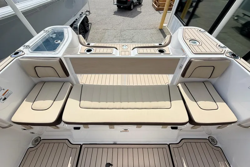 Slide: The Image of 2026 Yamaha Boats 255 FSH Sport H interior with beige seating and sleek design. - 25