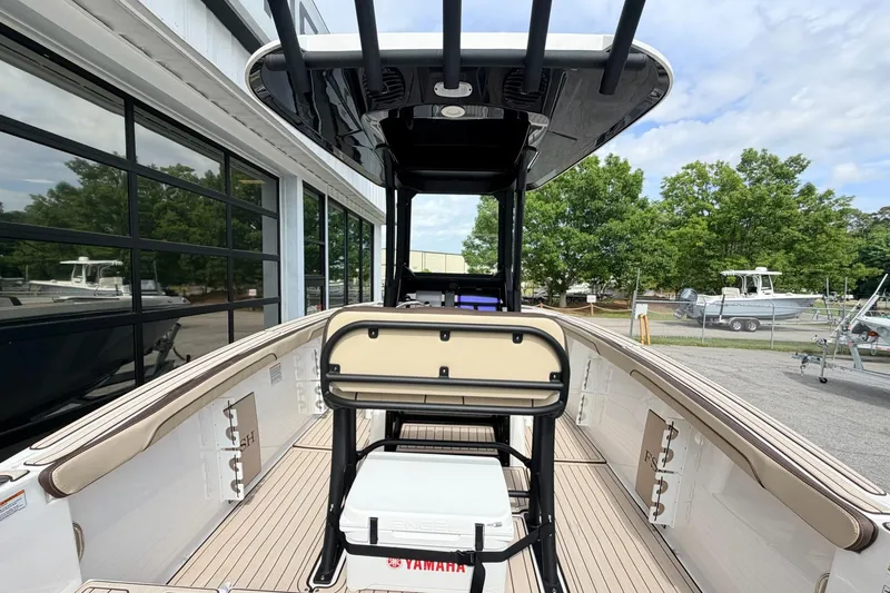 Slide: The Image of 2026 Yamaha Boats 255 FSH Sport H interior view, showcasing seating and deck design. - 6