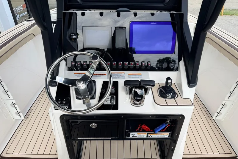 Slide: The Image of 2026 Yamaha Boats 255 FSH Sport H dashboard with steering wheel and control panel. - 7