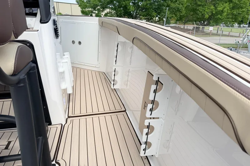 Slide: The Image of 2026 Yamaha Boats 255 FSH Sport H interior with sleek seating and storage compartments. - 8