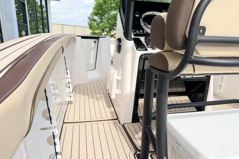 Slide: The Image of 2026 Yamaha Boats 255 FSH Sport H interior with beige seating and sleek design. - 9