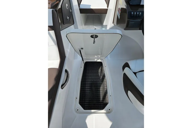 Slide: The Image of Open storage compartment on 2020 Monterey M-225 boat, featuring sleek interior design. - 10