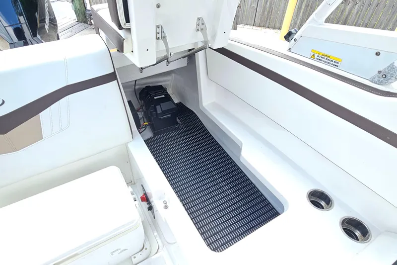 Slide: The Image of 2020 Monterey M-225 boat interior with storage compartment and battery setup. - 17