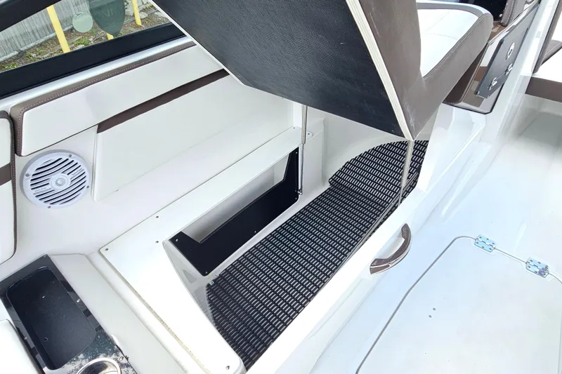 Slide: The Image of 2020 Monterey M-225 boat interior with open storage compartment and speaker. - 18