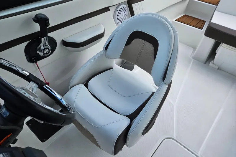 Slide: The Image of Captain's seat in a 2020 Monterey M-225 boat, featuring sleek design and modern controls. - 20