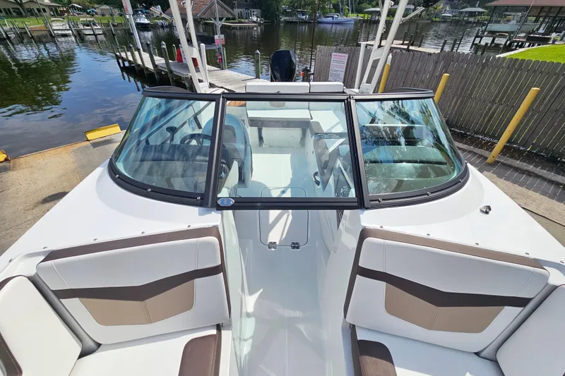 Slide: The Image of 2020 Monterey M-225 boat with sleek design docked by a scenic waterfront. - 23