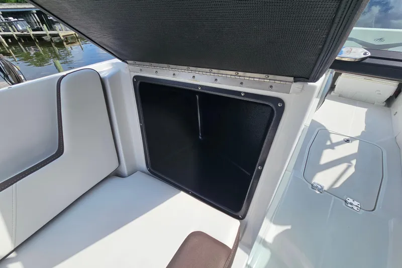 Slide: The Image of Open storage compartment on a 2020 Monterey M-225 boat, dockside view. - 24