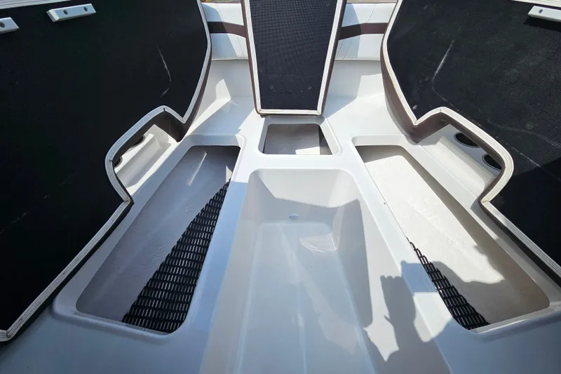 Slide: The Image of Interior view of a 2020 Monterey M-225 boat, showcasing seating and storage compartments. - 26