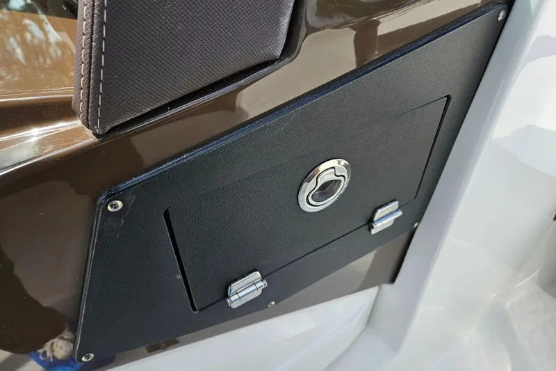 Slide: The Image of 2020 Monterey M-225 boat storage compartment with secure latch and sleek design. - 27