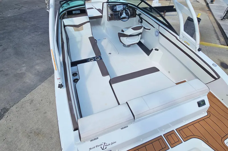 Slide: The Image of 2020 Monterey M-225 boat interior with white and brown seating, sleek design. - 29