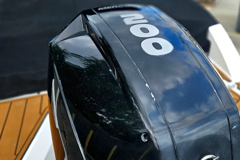 Slide: The Image of Close-up of a 2020 Monterey M-225 boat engine with reflective black surface. - 4