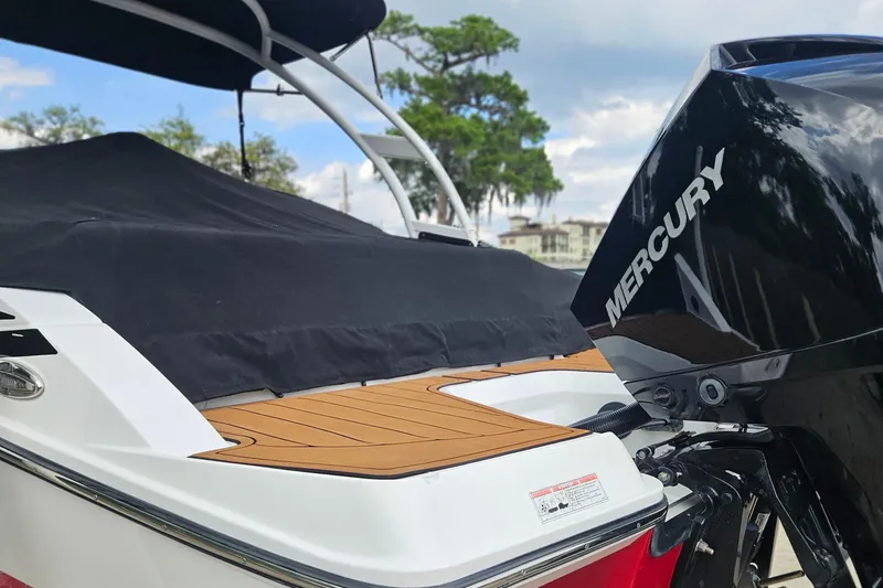 Slide: The Image of 2020 Monterey M-225 boat with Mercury engine, covered deck, and scenic background. - 5
