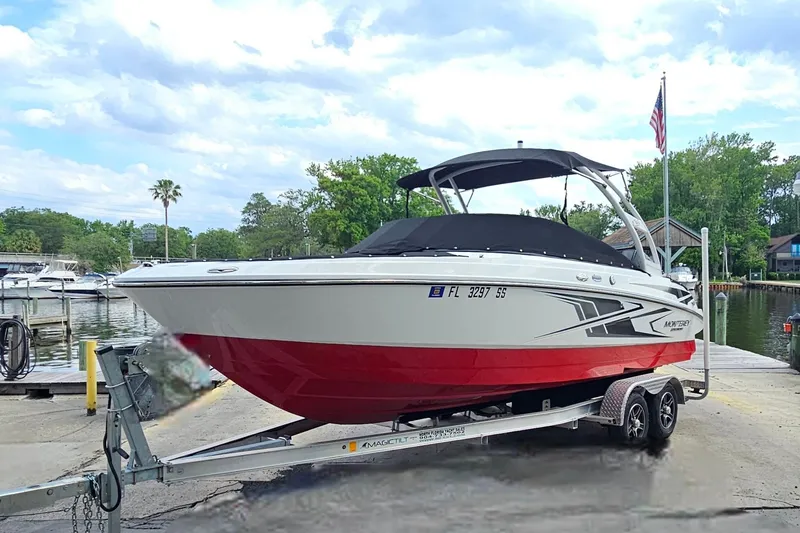 Slide: The Image of 2020 Monterey M-225 boat on trailer by lakeside dock, under cloudy sky. - 7
