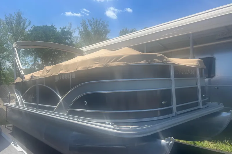 Slide: The Image of 2017 Sylvan Mirage Cruise 8520 CR LZ pontoon boat with cover, parked outdoors. - 3