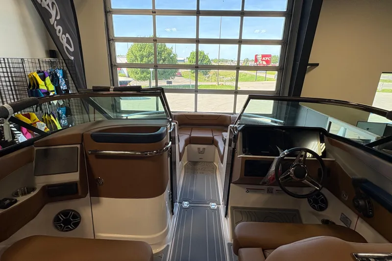 Slide: The Image of Interior view of a 2026 Regal LS6 boat, showcasing seating and dashboard features. - 13