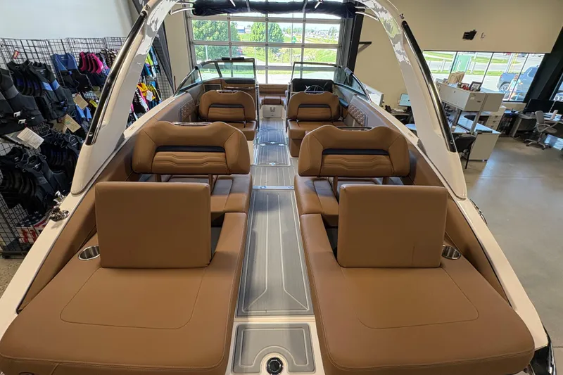 Slide: The Image of 2026 Regal LS6 boat interior with luxurious brown seating and modern design in showroom. - 20