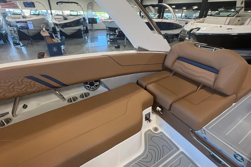 Slide: The Image of Luxurious interior of 2026 Regal LS6 boat with brown leather seating in showroom. - 8