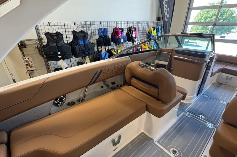 Slide: The Image of 2026 Regal LS6 boat interior with brown leather seating and modern dashboard. - 9