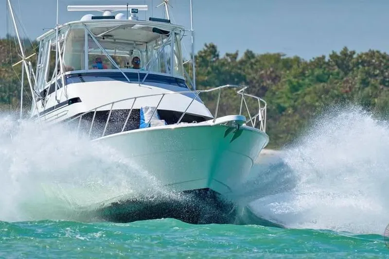 The Image of 1991 Hatteras 43 Convertible yacht cruising through waves, showcasing power and elegance. - 0