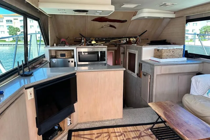 Slide: The Image of Cozy bedroom interior of 1991 Hatteras 43 Convertible yacht with skylight and colorful pillows. - 10