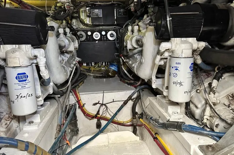 Slide: The Image of Engine room of a 1991 Hatteras 43 Convertible boat, showcasing mechanical components and filters. - 16