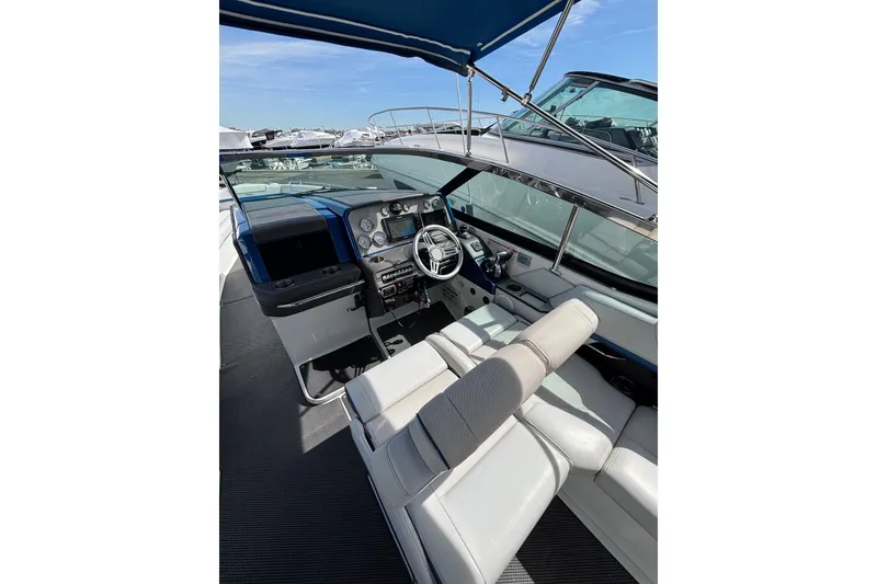 Slide: The Image of 2018 Formula 330 Crossover Bowrider I/O cockpit with modern dashboard and seating. - 10