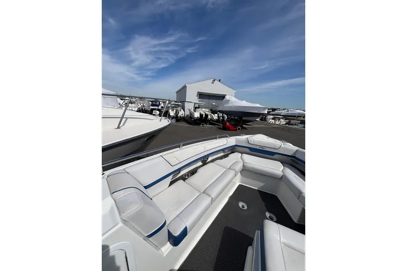 Slide: The Image of 2018 Formula 330 Crossover Bowrider I/O in marina, showcasing spacious seating and sleek design. - 13