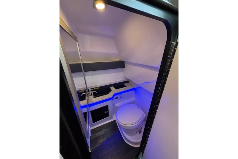 Slide: The Image of 2018 Formula 330 Crossover Bowrider I/O bathroom with modern fixtures and ambient lighting. - 16