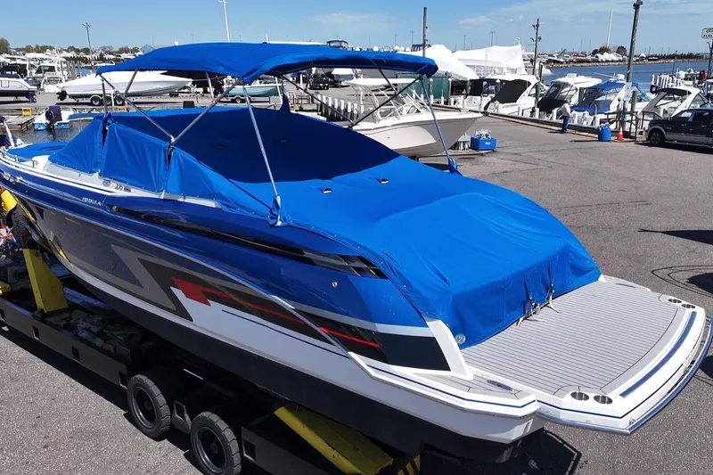 Slide: The Image of 2018 Formula 330 Crossover Bowrider I/O with blue cover at marina dock. - 23