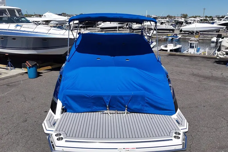 Slide: The Image of 2018 Formula 330 Crossover Bowrider I/O with blue cover at marina. - 25