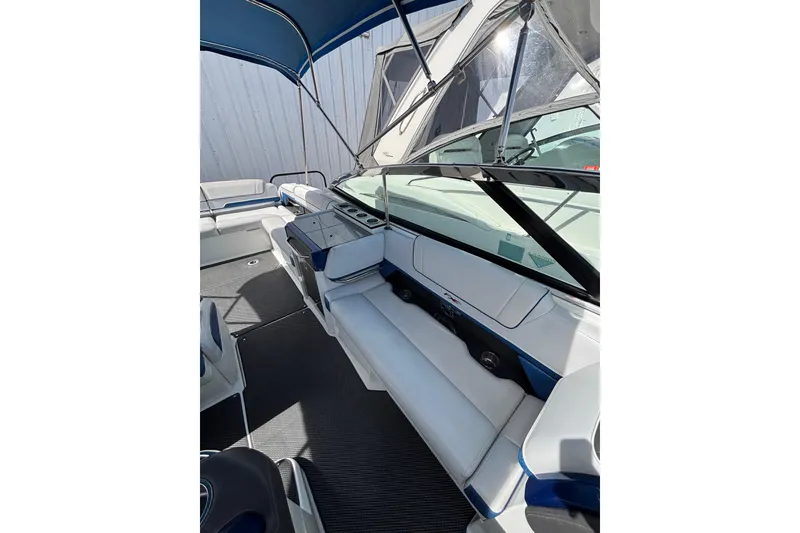 Slide: The Image of 2018 Formula 330 Crossover Bowrider I/O interior with seating and canopy. - 8