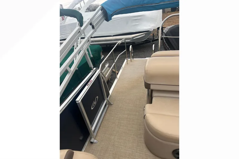 Slide: The Image of 2019 Harris Cruiser 210 pontoon boat with beige seating and railing. - 17