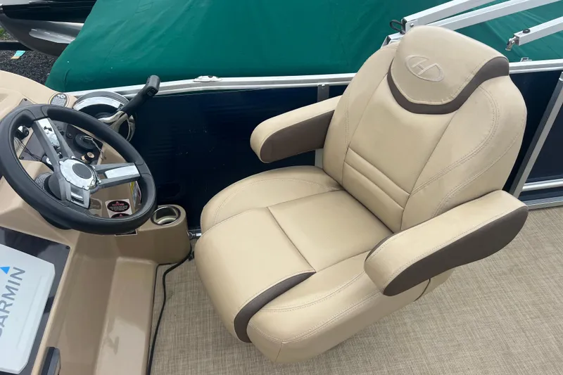 Slide: The Image of Captain's chair and steering wheel of a 2019 Harris Cruiser 210 boat. - 18