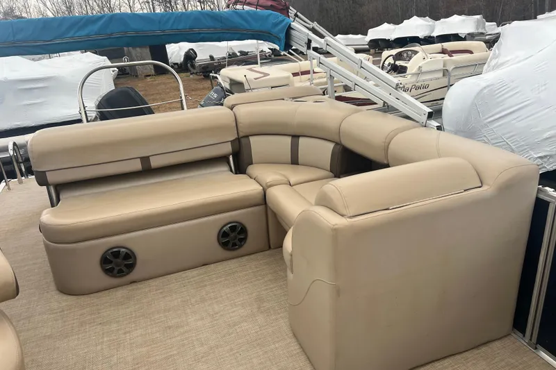 Slide: The Image of 2019 Harris Cruiser 210 boat interior with beige seating and speakers. - 20